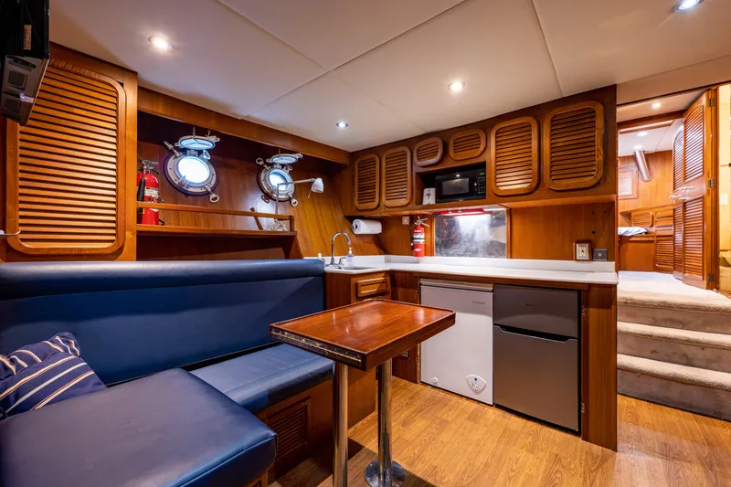 Slide: The Image of Interior of 1985 Cheoy Lee 90 Motor Yacht with wood paneling and cozy seating area. - 39