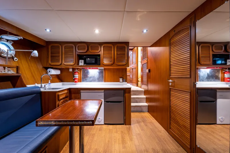 Slide: The Image of Interior of 1985 Cheoy Lee 90 Motor Yacht with wood finishes and modern amenities. - 40