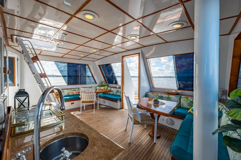 Slide: The Image of Luxurious interior of 1985 Cheoy Lee 90 Motor Yacht with panoramic windows and elegant seating. - 46