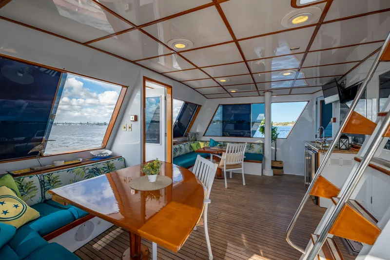 Slide: The Image of Luxurious 1985 Cheoy Lee 90 Motor Yacht interior with elegant seating and dining area. - 48