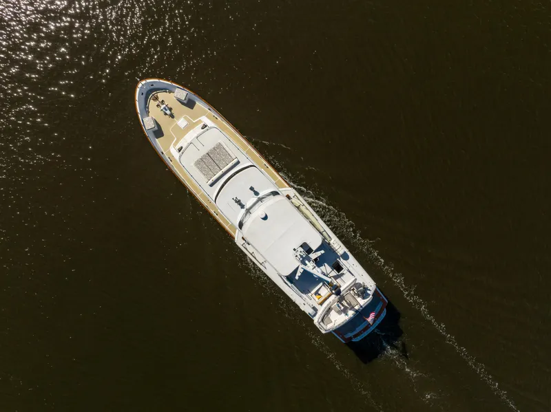 Slide: The Image of Aerial view of 1985 Cheoy Lee 90 Motor Yacht cruising on dark water. - 6