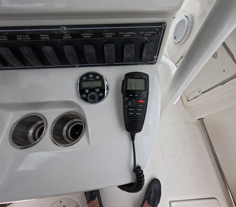 Slide: The Image of Control panel of a 2013 Boston Whaler 320 Outrage with radio and cup holders. - 10