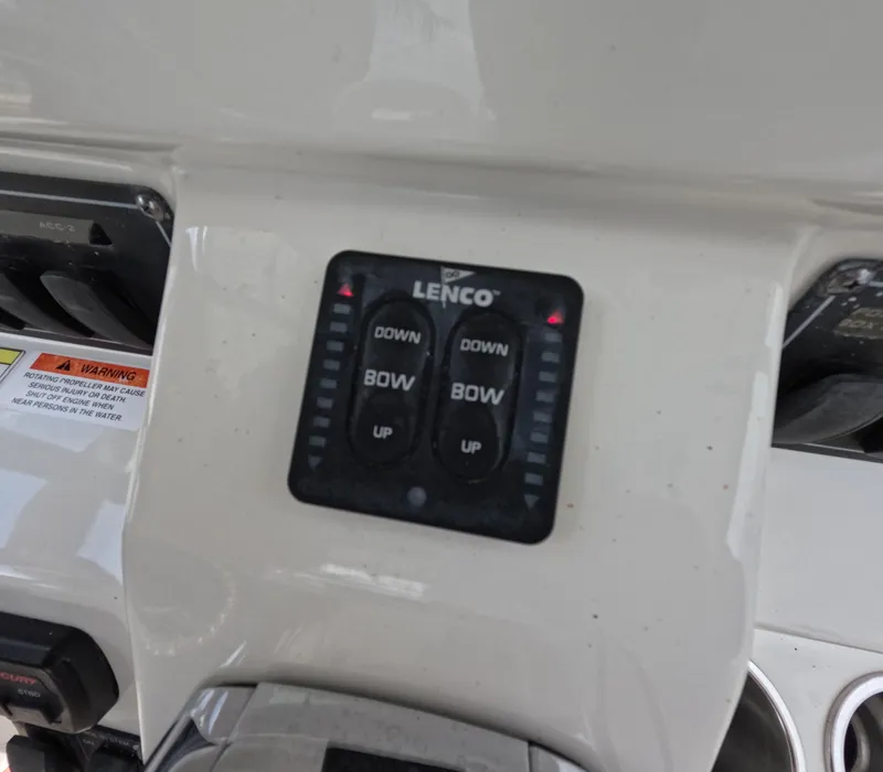 Slide: The Image of Control panel of a 2013 Boston Whaler 320 Outrage boat with Lenco trim tab switches. - 11