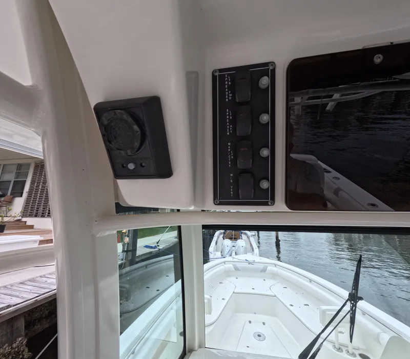 Slide: The Image of Interior view of 2013 Boston Whaler 320 Outrage boat, showing control panel and windshield. - 13