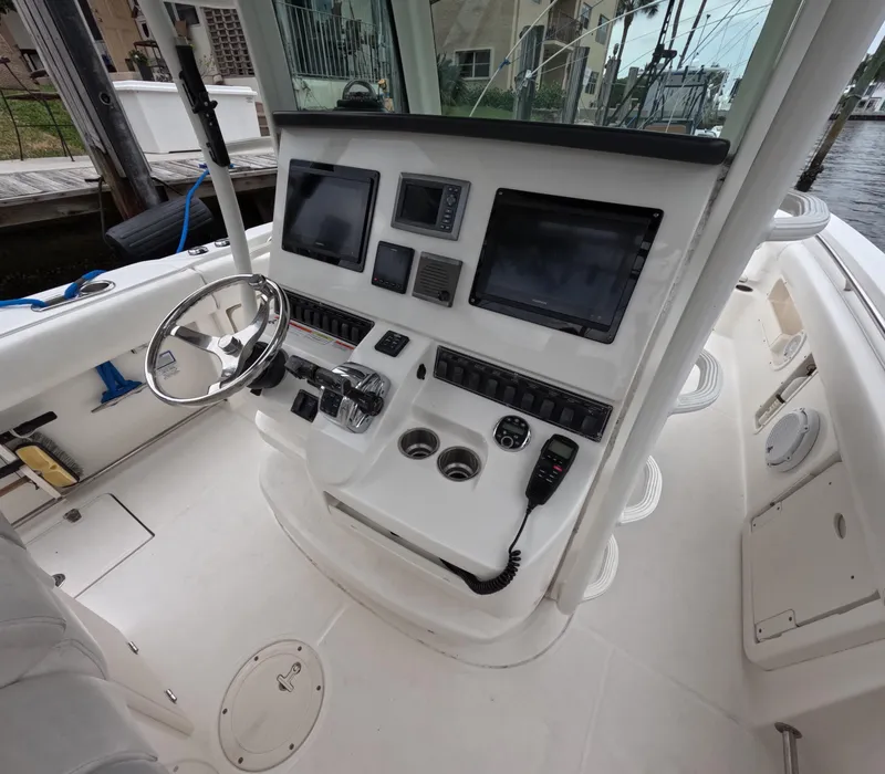 Slide: The Image of 2013 Boston Whaler 320 Outrage helm with modern navigation equipment and controls. - 14