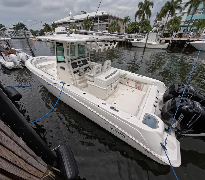 Slide: The Image of 2013 Boston Whaler 320 Outrage boat docked in marina with twin engines. - 26