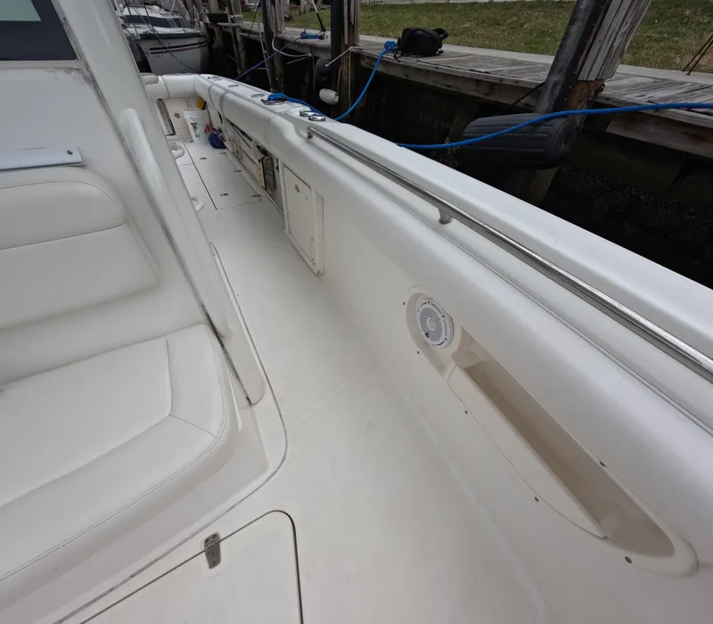 Slide: The Image of 2013 Boston Whaler 320 Outrage boat interior with white seating and deck details. - 35