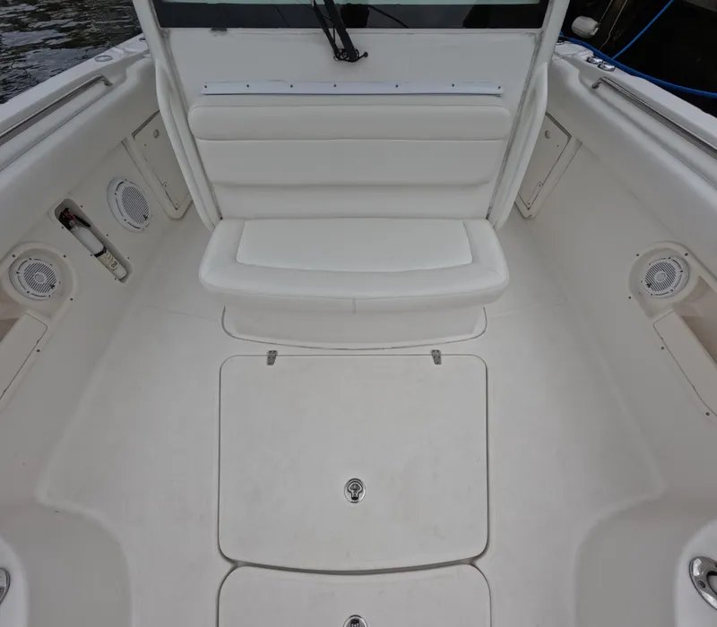 Slide: The Image of 2013 Boston Whaler 320 Outrage boat interior with seating and storage compartments. - 38