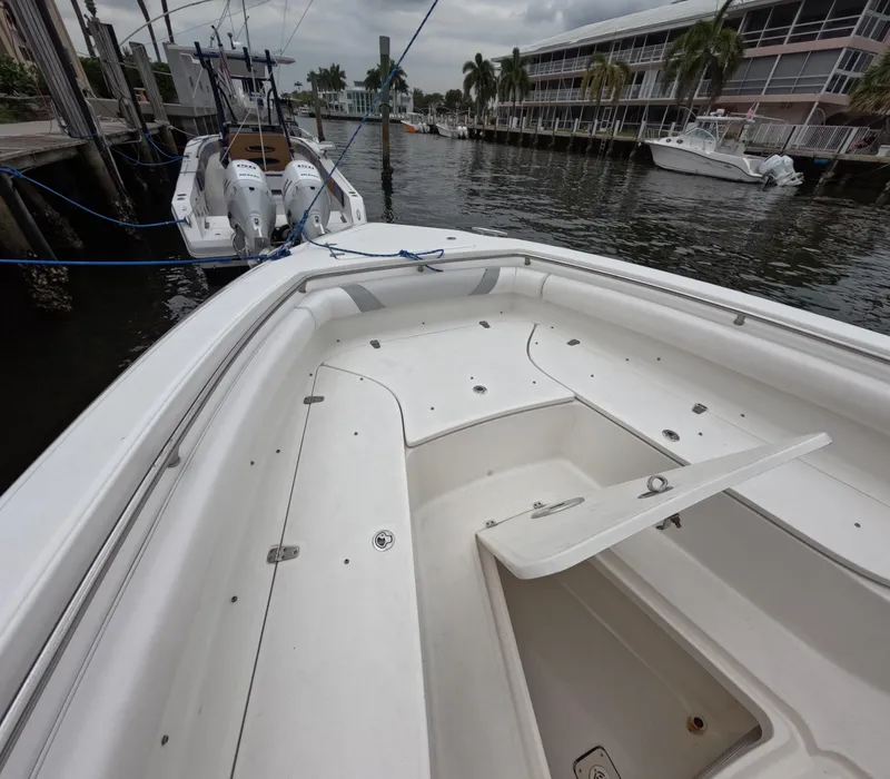 Slide: The Image of 2013 Boston Whaler 320 Outrage boat docked at marina with palm trees. - 39