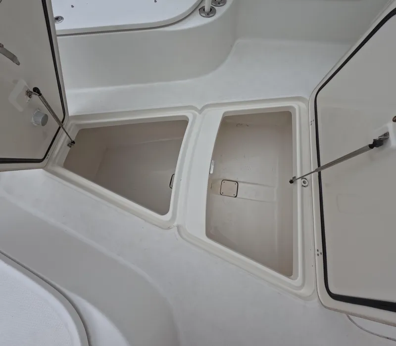 Slide: The Image of Open storage compartments on a 2013 Boston Whaler 320 Outrage boat. - 42