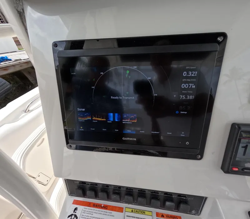 Slide: The Image of Garmin display on 2013 Boston Whaler 320 Outrage boat dashboard, showing sonar and navigation data. - 6