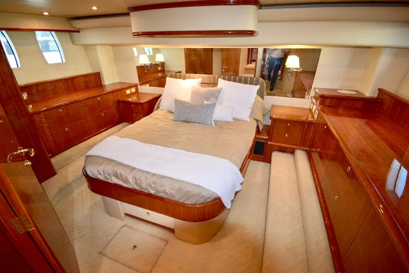 Slide: The Image of Luxurious Neptunus 58 yacht bedroom, 2010 model, featuring elegant wood finishes and cozy bedding. - 13