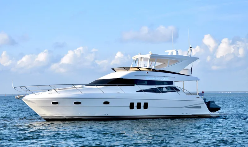 Slide: The Image of Luxury 2010 Neptunus 58 yacht cruising on open water under blue sky. - 2