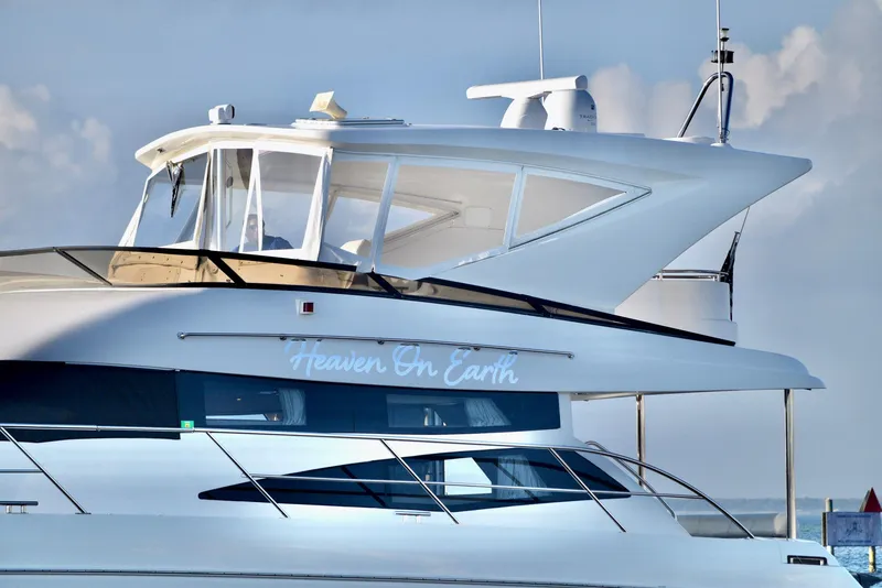 Slide: The Image of Luxury Neptunus 58 yacht, 2010 model, named "Heaven On Earth" against a clear sky. - 22