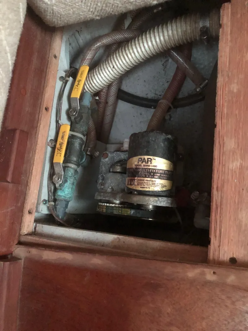 Slide: The Image of 1984 Tartan T-33 boat interior showing plumbing and pump system components. - 13