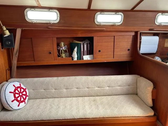 Slide: The Image of Interior of 1984 Tartan T-33 sailboat with cushioned seating and nautical decor. - 16