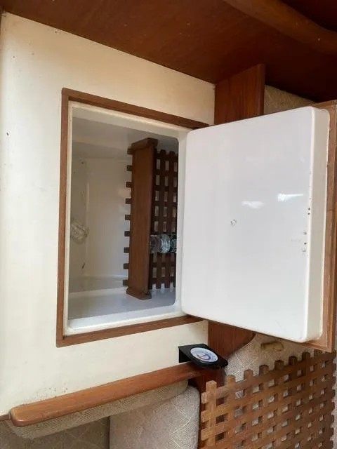 Slide: The Image of 1984 Tartan T-33 interior with open storage compartment and wooden lattice detail. - 19