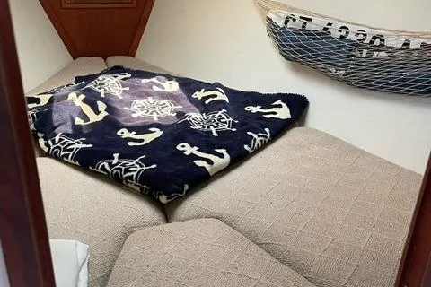 Slide: The Image of Cozy cabin interior of 1984 Tartan T-33 sailboat with nautical-themed blanket. - 24