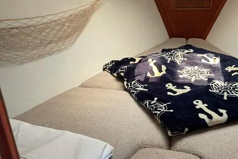 Slide: The Image of Cozy cabin interior of 1984 Tartan T-33 sailboat with nautical-themed blanket. - 25