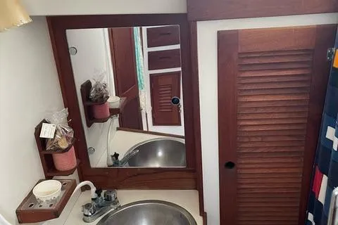 Slide: The Image of 1984 Tartan T-33 yacht bathroom with wooden cabinetry and stainless steel sink. - 26
