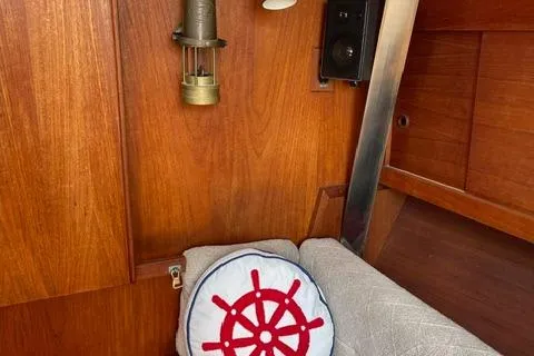 Slide: The Image of Interior of 1984 Tartan T-33 sailboat with nautical decor and wooden paneling. - 27