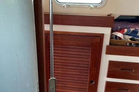 Slide: The Image of Interior of 1984 Tartan T-33 sailboat with wooden cabinetry and storage compartments. - 29