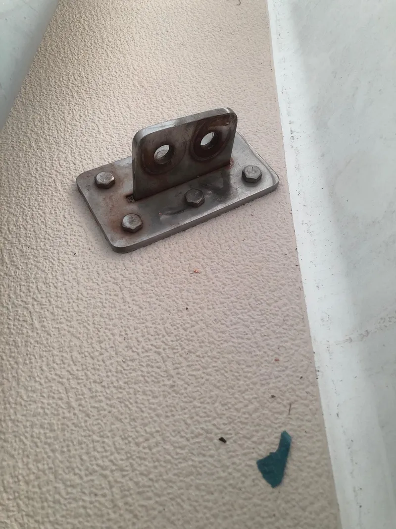 Slide: The Image of Metal bracket on Tartan T-33 boat, 1984 model, mounted on textured surface. - 9