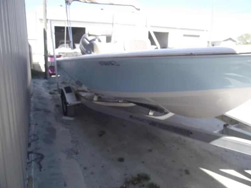 Slide: The Image of 2022 Tidewater 1910 Bay Max boat on trailer, parked outdoors. - 2