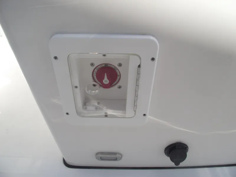 Slide: The Image of 2022 Tidewater 1910 Bay Max boat control panel with red dial and plug socket. - 21