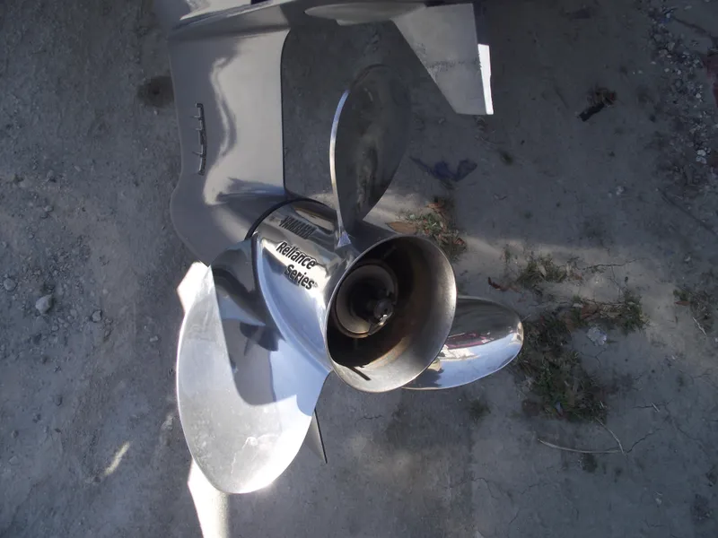 Slide: The Image of Close-up of a Tidewater 1910 Bay Max 2022 boat propeller on a sandy surface. - 4