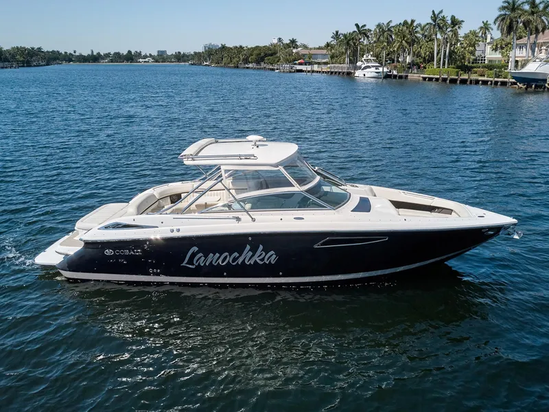 Slide: The Image of 2016 Cobalt 336 boat cruising on a sunny day in a scenic waterway. - 1