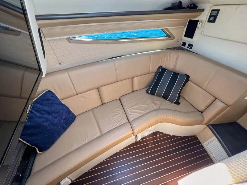 Slide: The Image of Luxurious interior of a 2016 Cobalt 336 boat with leather seating and decorative pillows. - 10