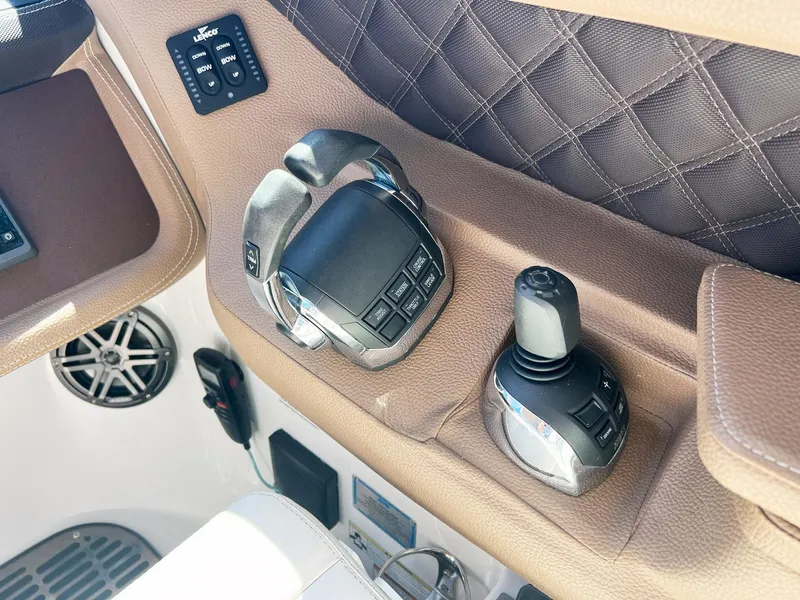 Slide: The Image of Control panel of a 2016 Cobalt 336 boat with joystick and throttle. - 16