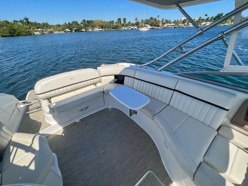 Slide: The Image of Luxurious 2016 Cobalt 336 boat interior with white seating and table on a sunny day. - 19