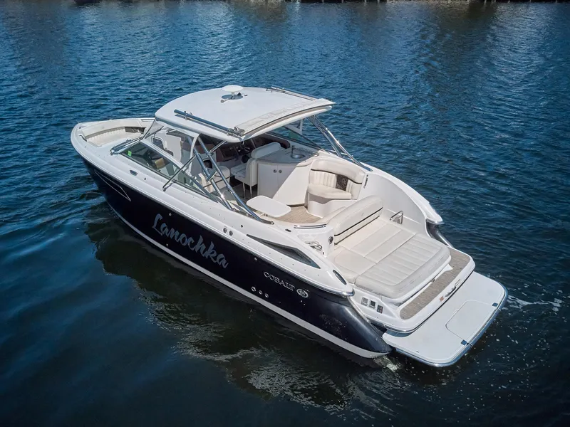 Slide: The Image of 2016 Cobalt 336 boat on water, featuring sleek design and spacious seating. - 24