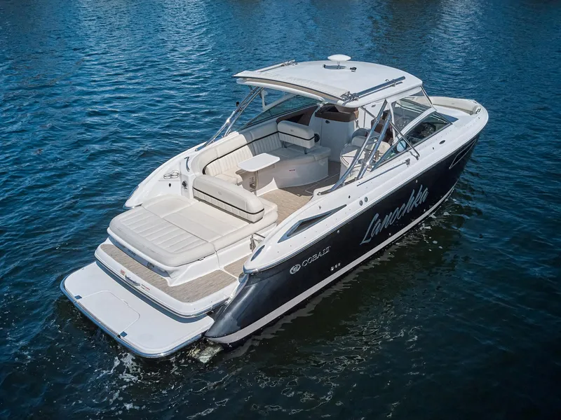 Slide: The Image of 2016 Cobalt 336 boat on water, featuring sleek design and spacious seating. - 26