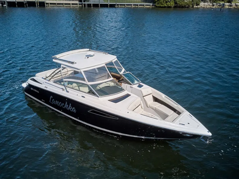 Slide: The Image of 2016 Cobalt 336 boat on calm water, featuring sleek design and spacious seating. - 27