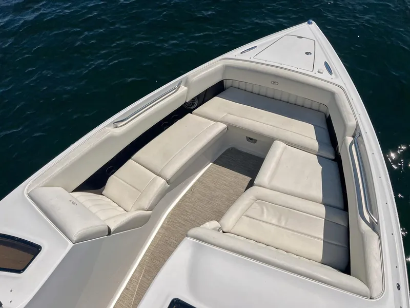Slide: The Image of 2016 Cobalt 336 boat with spacious white seating on calm water. - 4