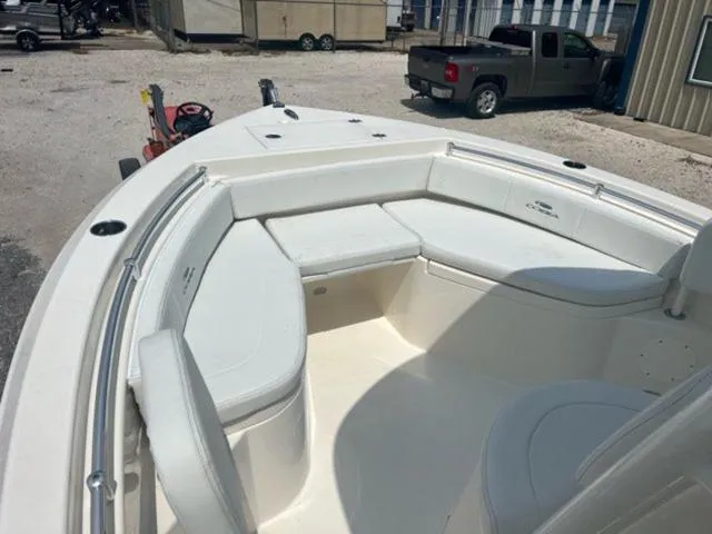 Slide: The Image of 2024 Cobia 220 CC boat with spacious seating and sleek design. - 13