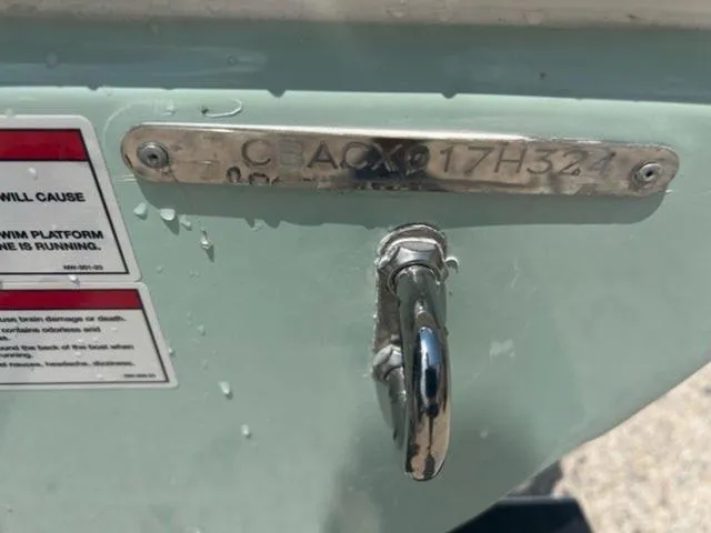 Slide: The Image of 2024 Cobia 220 CC boat identification plate and hook detail. - 14