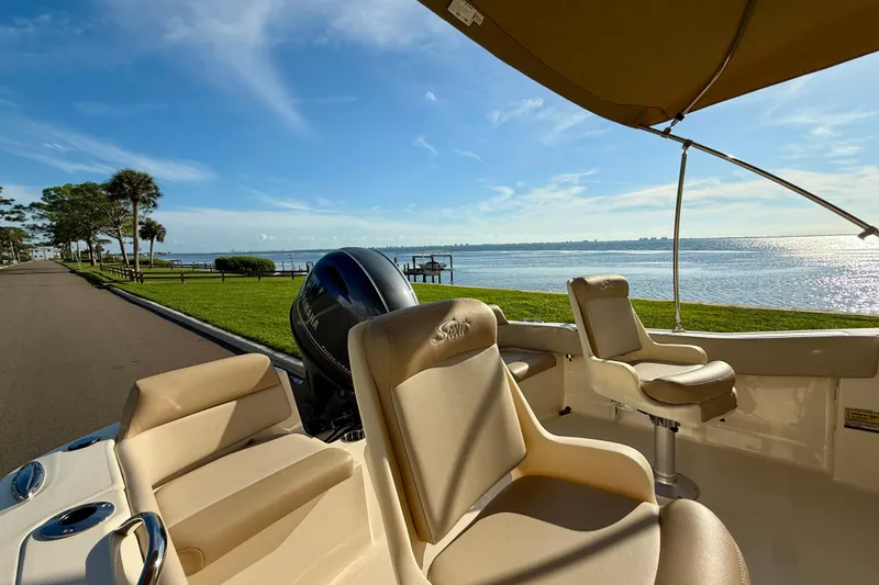 Slide: The Image of 2025 Scout 195 Sport Dorado boat interior with scenic waterfront view. - 12