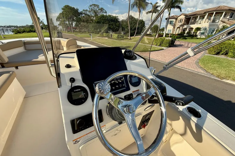 Slide: The Image of 2025 Scout 195 Sport Dorado boat interior with steering wheel and control panel. - 16