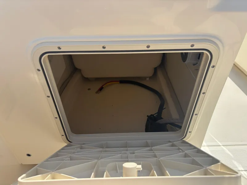 Slide: The Image of Open storage compartment on 2025 Scout 195 Sport Dorado boat. - 21