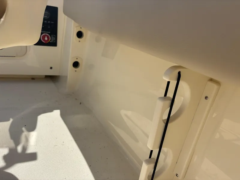 Slide: The Image of 2025 Scout 195 Sport Dorado interior detail with storage and control panel. - 23