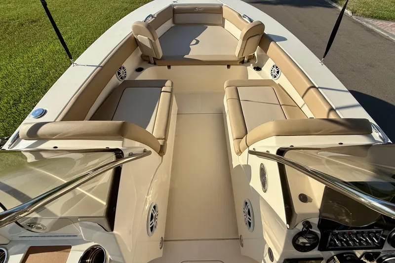 Slide: The Image of 2025 Scout 195 Sport Dorado boat interior with beige seating and modern dashboard. - 25
