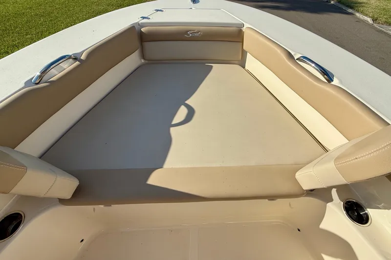 Slide: The Image of 2025 Scout 195 Sport Dorado boat interior with beige seating and stainless steel handles. - 26