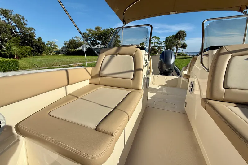 Slide: The Image of 2025 Scout 195 Sport Dorado boat interior with beige seating and scenic background. - 30