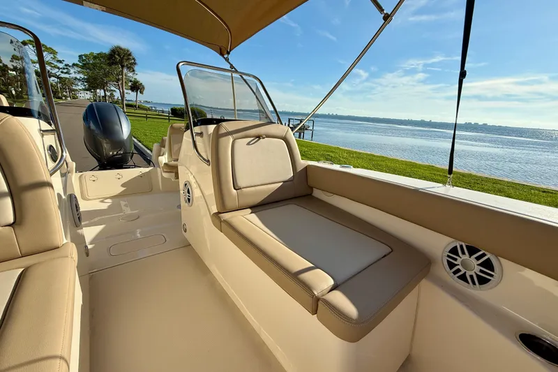Slide: The Image of 2025 Scout 195 Sport Dorado boat interior with seating, overlooking serene waterfront. - 32