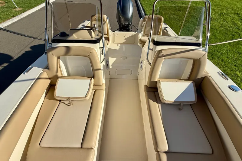 Slide: The Image of 2025 Scout 195 Sport Dorado boat interior with beige seating and windshield. - 34