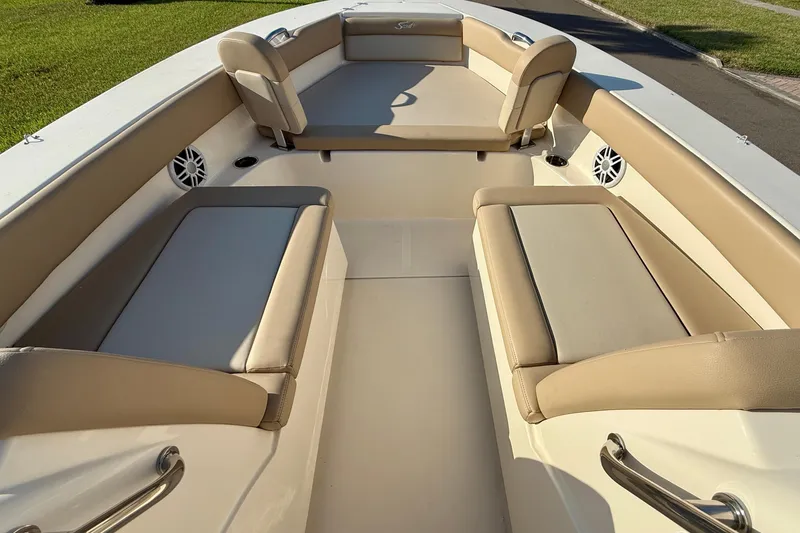Slide: The Image of 2025 Scout 195 Sport Dorado boat interior with beige seating and speakers. - 36